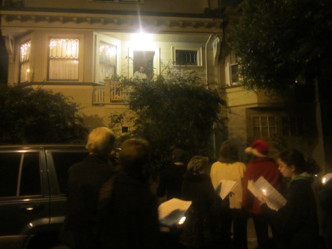 Carolers visit a house on Elsie Street.