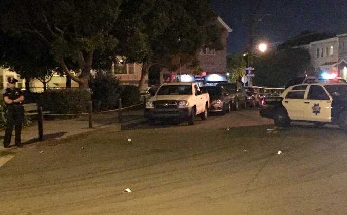 Markers on the street indicate where gun casings were found